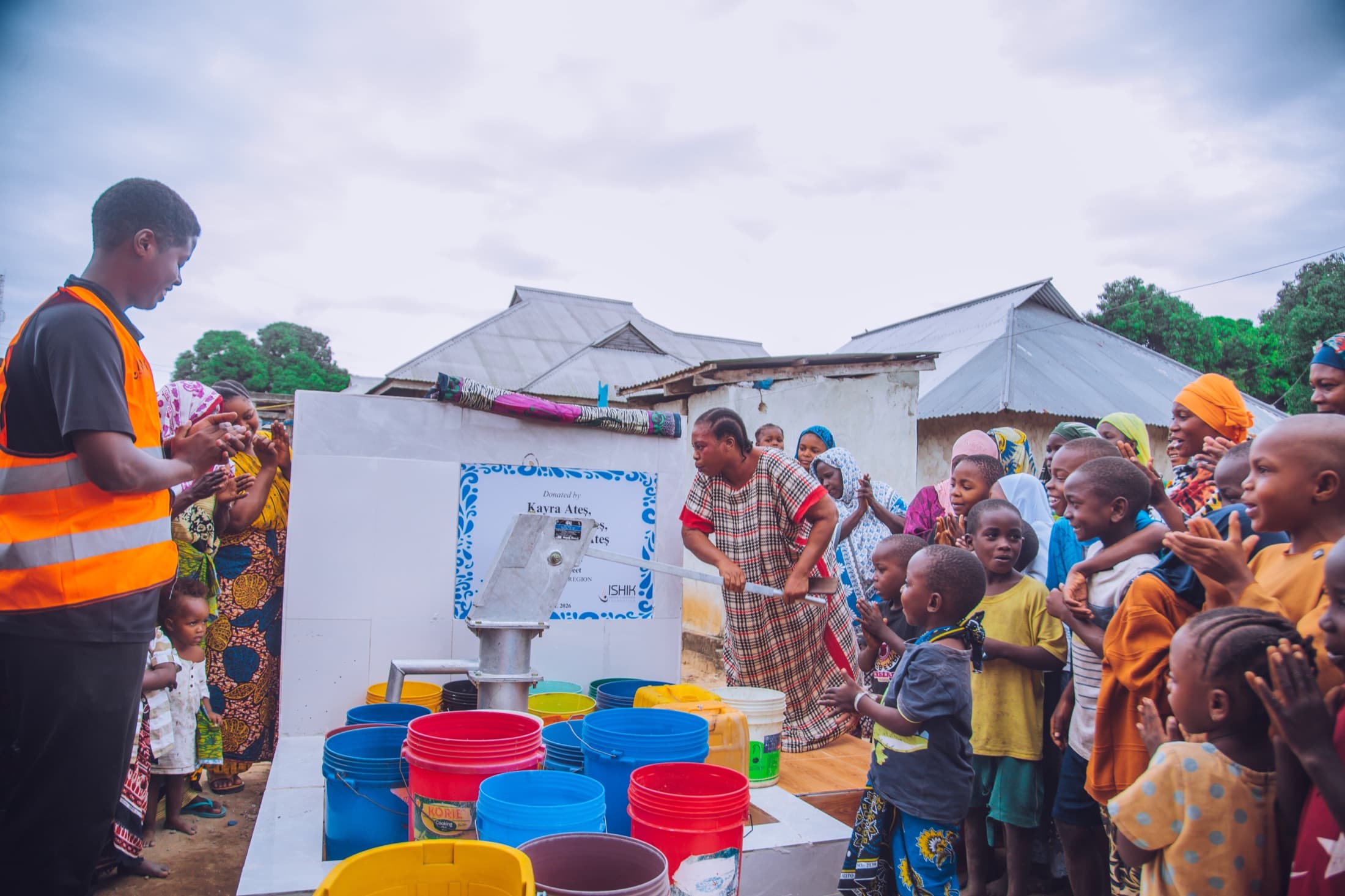 Community gathering at a newly completed Embrace Relief water well
