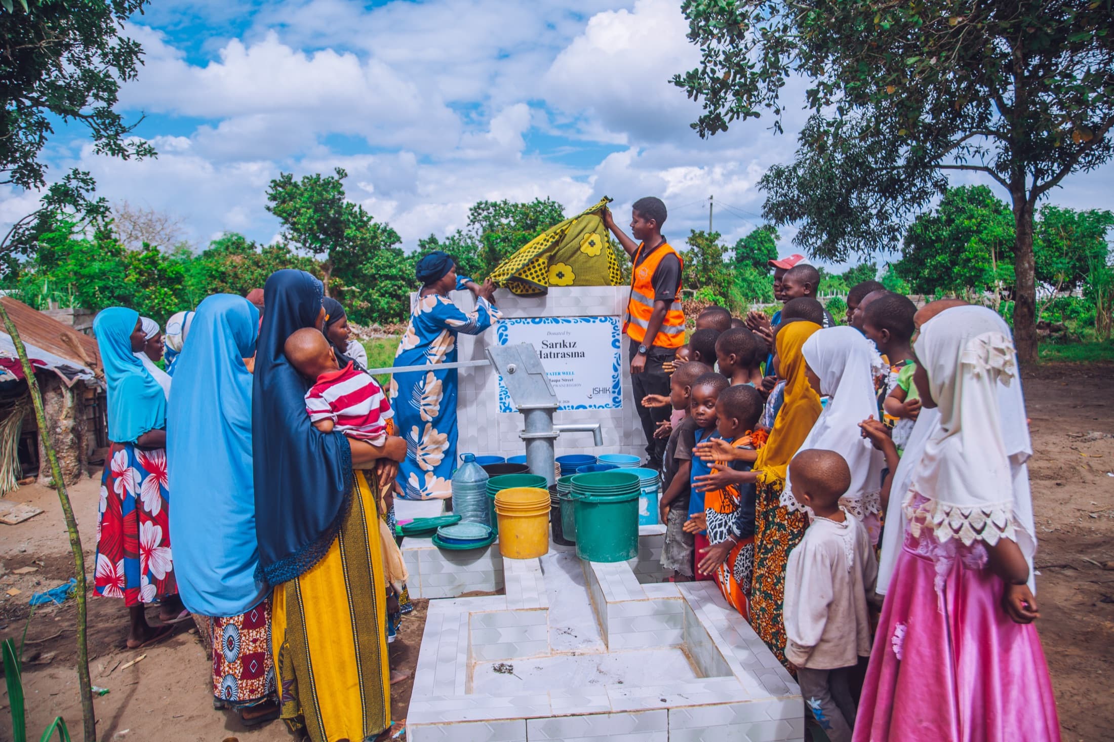 Families gathering at a new clean water well