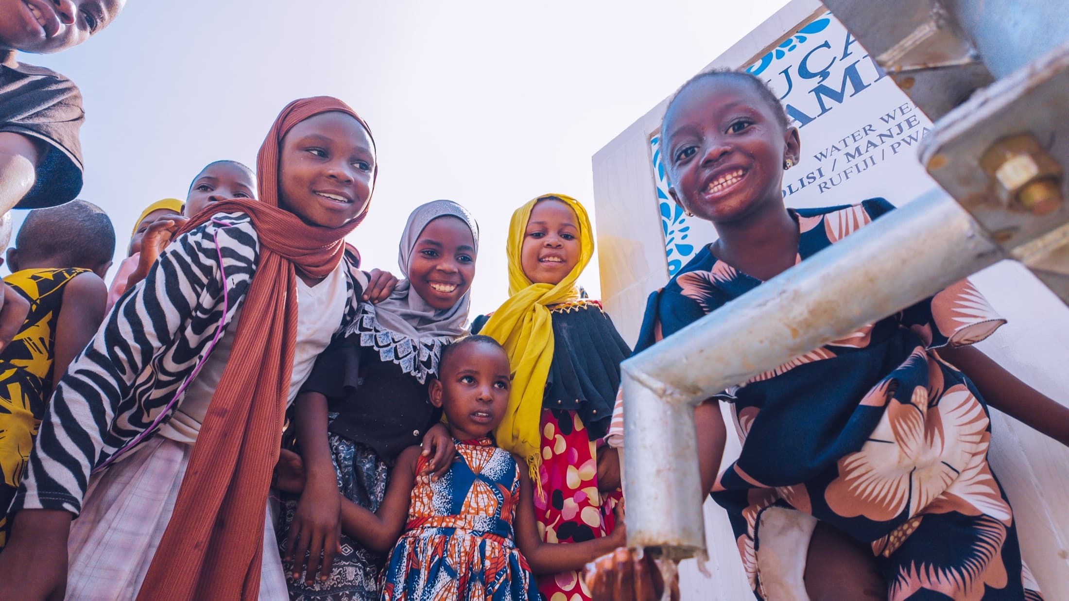 Children gathering at a restored community water point
