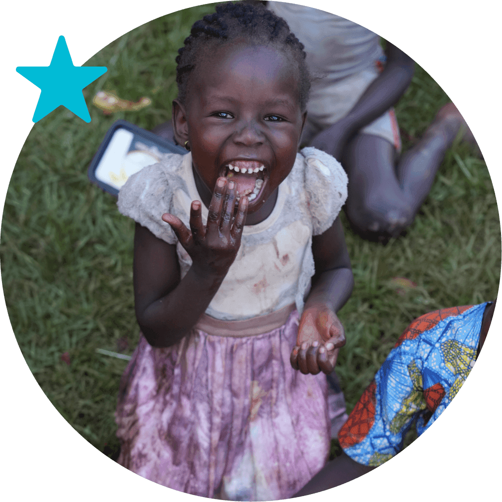A smiling child from Embrace Relief’s orphan care program