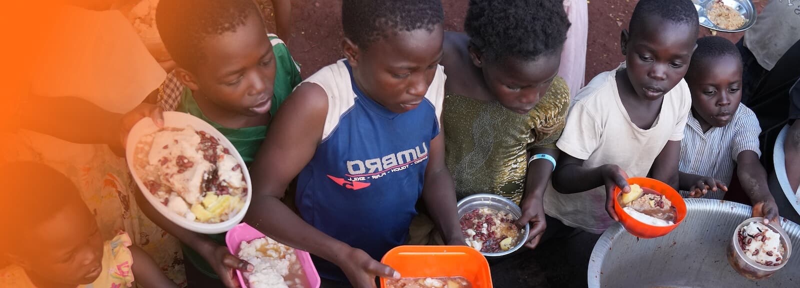 Children sharing a meal through Embrace Relief’s orphan care program