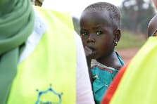 Child receiving care from an Embrace Relief volunteer
