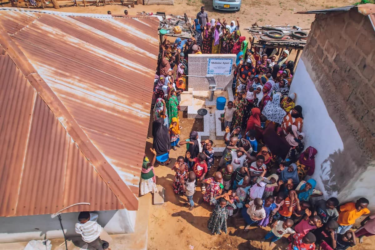 Community members gathered around a water well