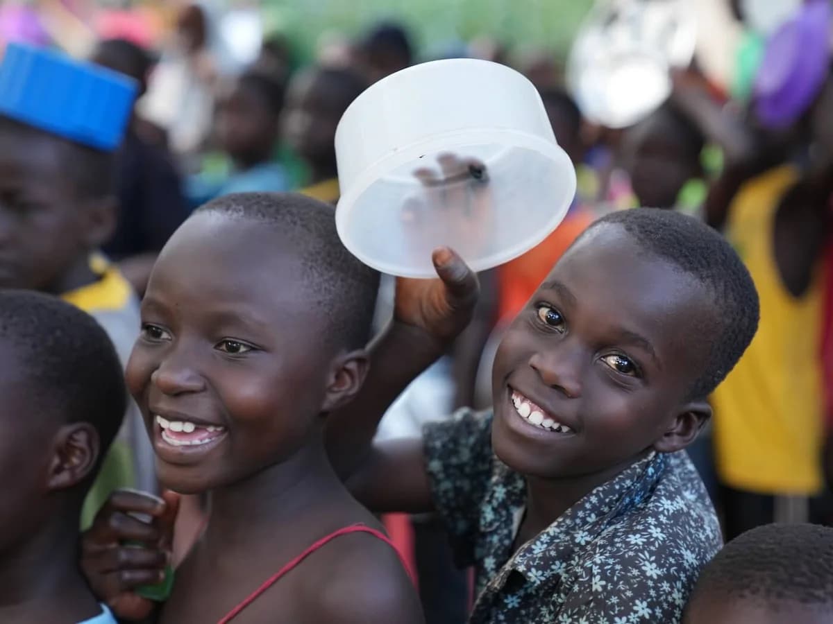 Children smiling together with their plates