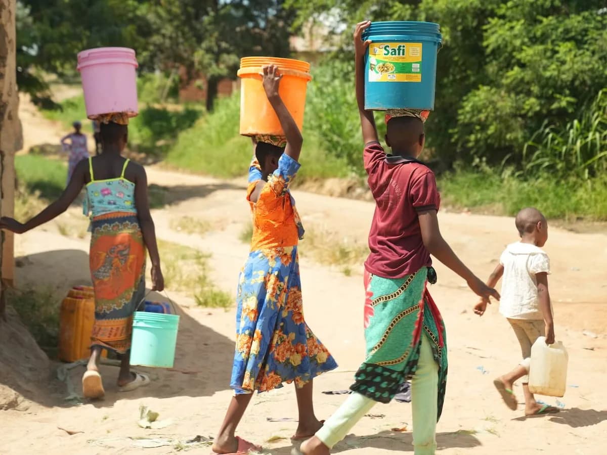 Families carrying water home