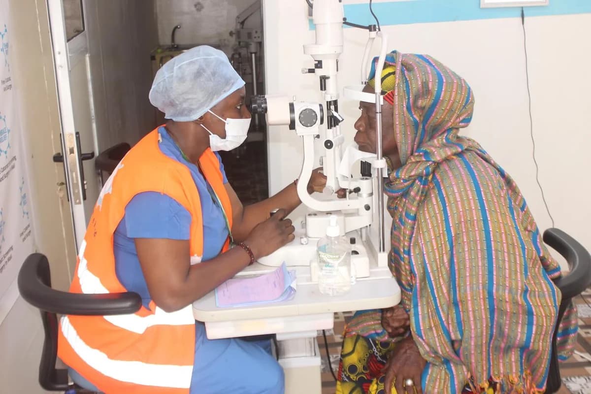 A clinician examining a patient’s eyes