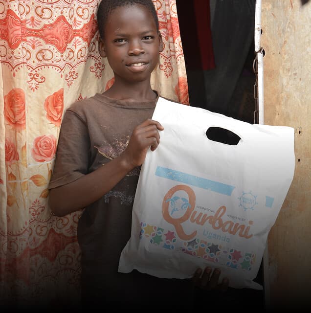 A child receiving a Qurbani meat package
