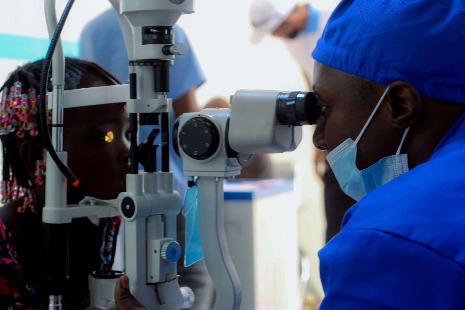 A health professional examining a patient’s eyes