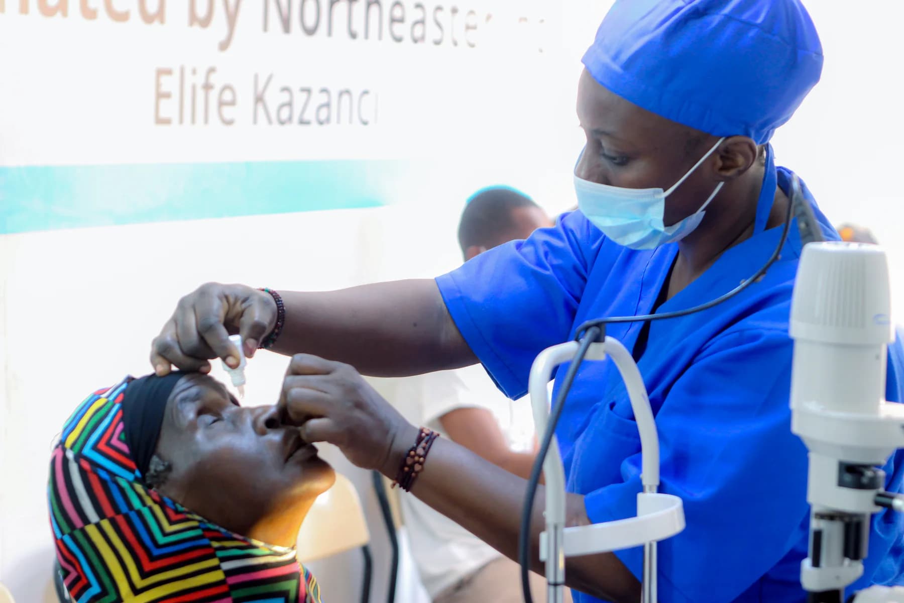 A clinician providing an eye examination