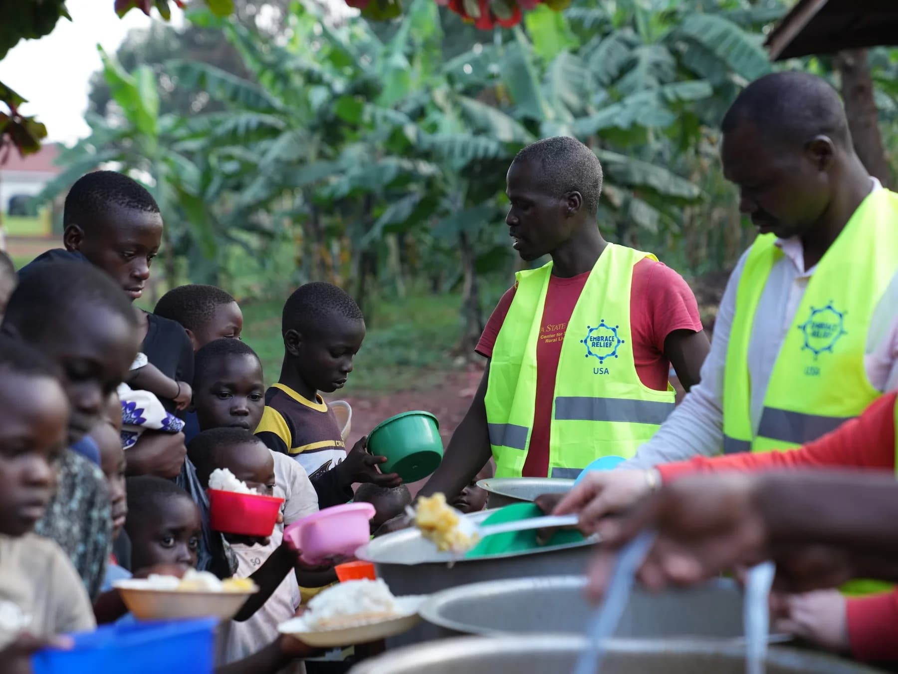 Embrace Relief volunteers serving meals to children