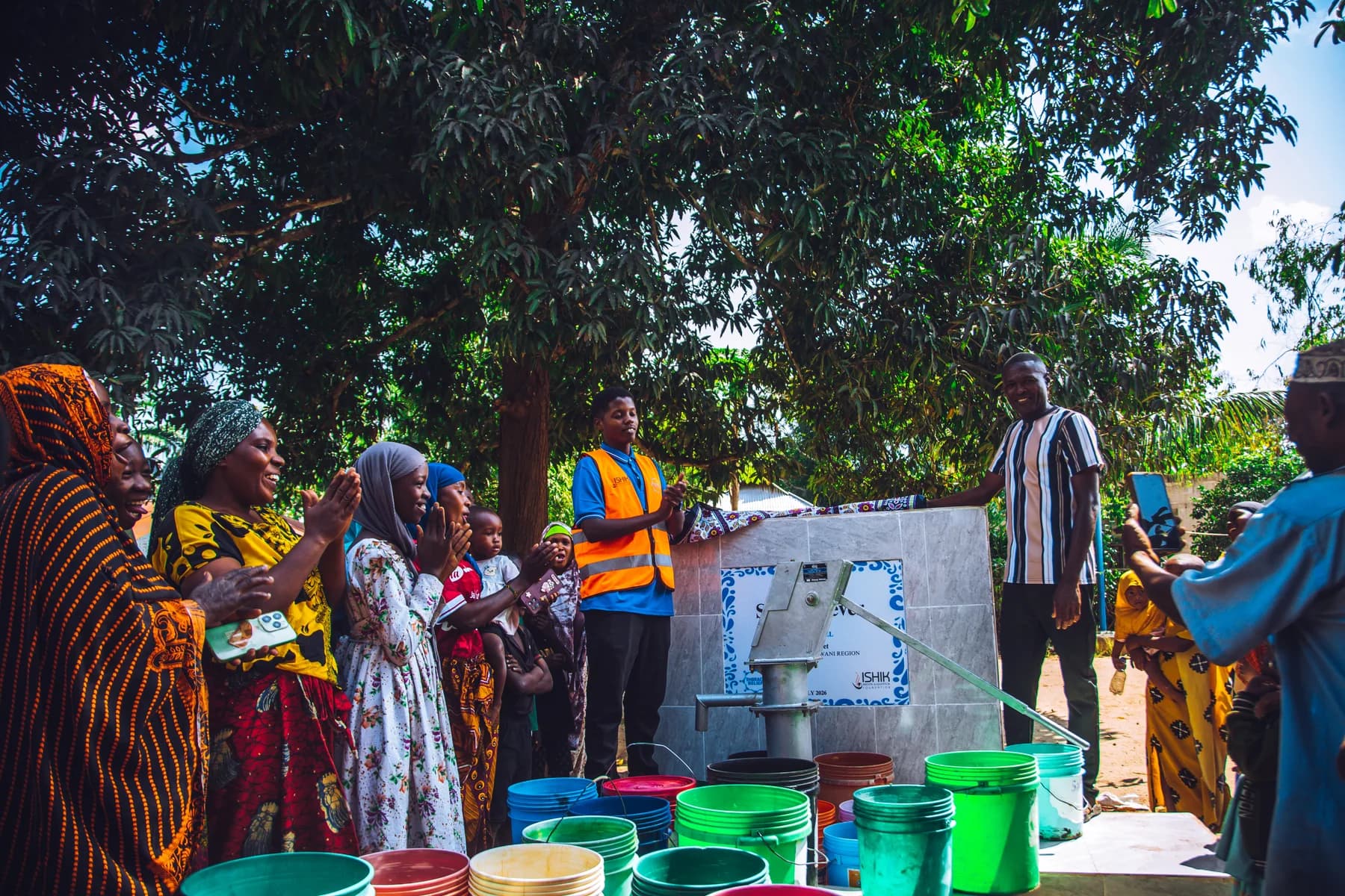 Community members collecting water from a well