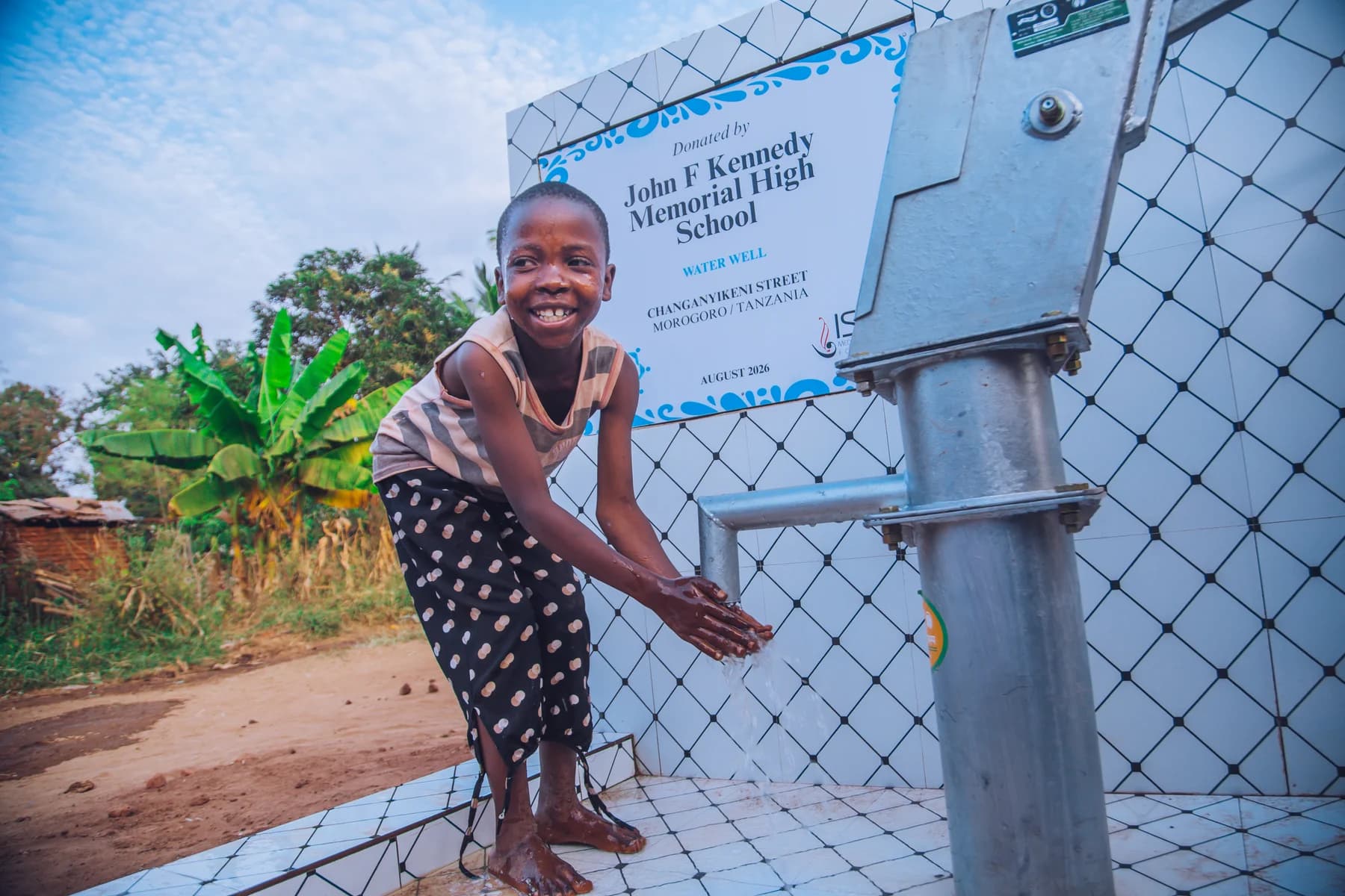 A child washing her hands at a community water well