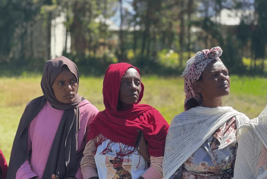 Women caring for chickens through Embrace Relief S.E.E.D. program