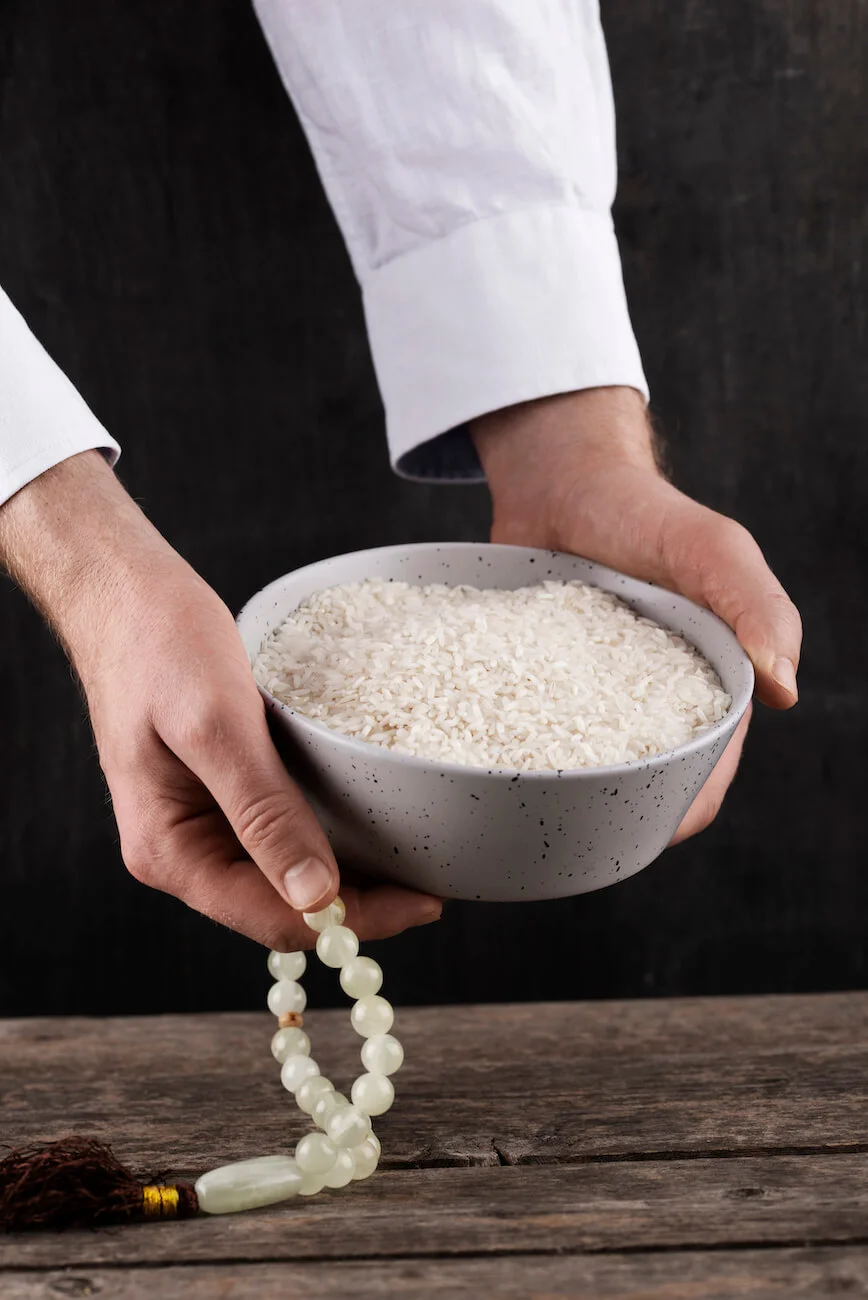 Hands holding a bowl representing Zakat donation