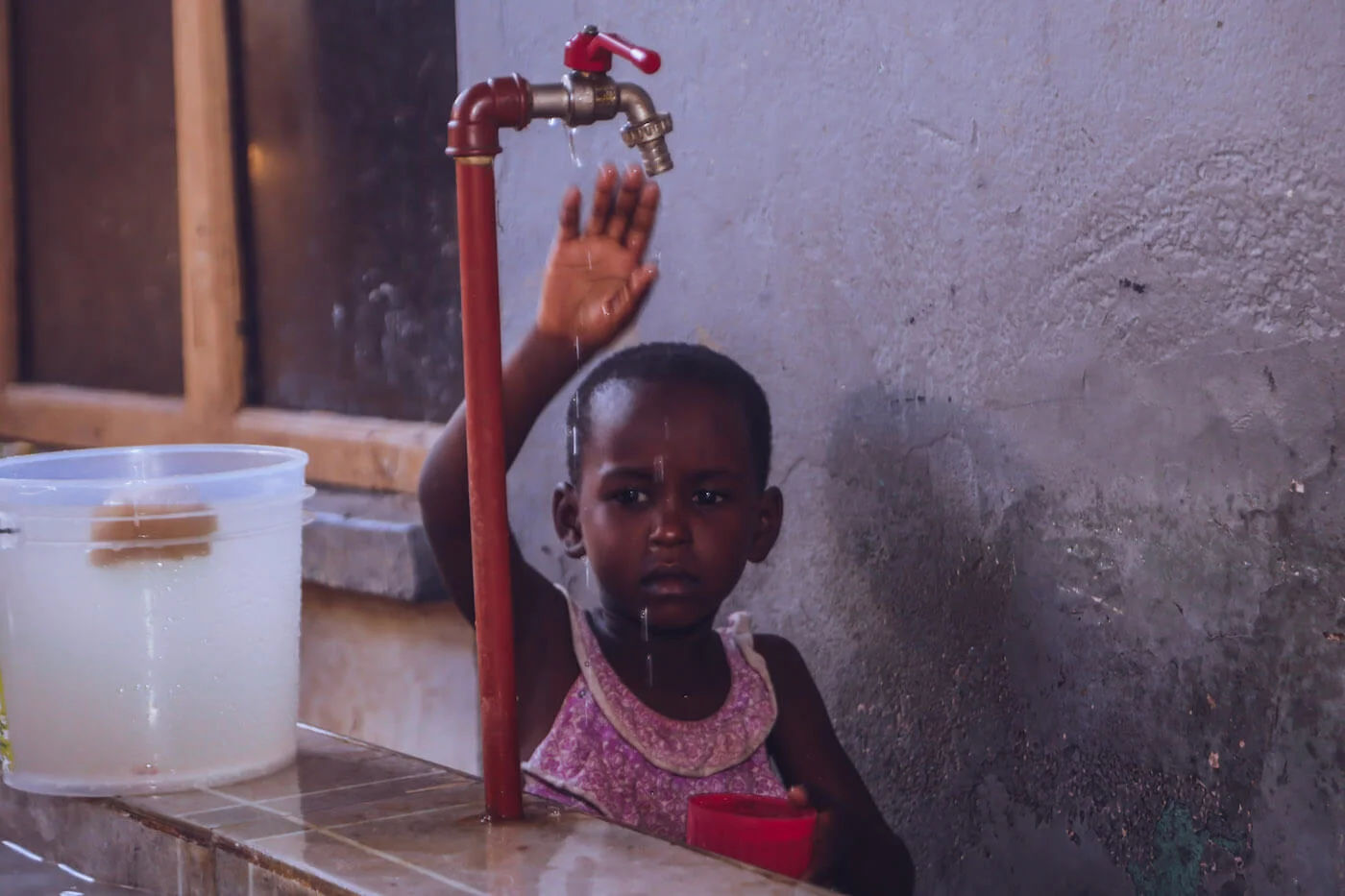 Orphaned children in an underdeveloped country facing water scarcity challenges