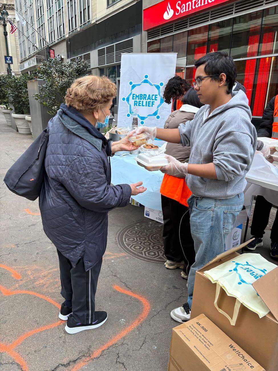Community partners and volunteers supporting Embrace Relief food distribution
