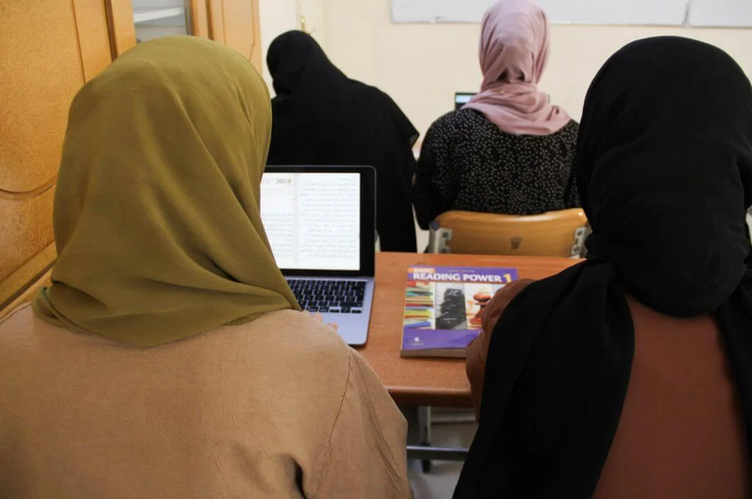 Young woman studying on a laptop in a home environment