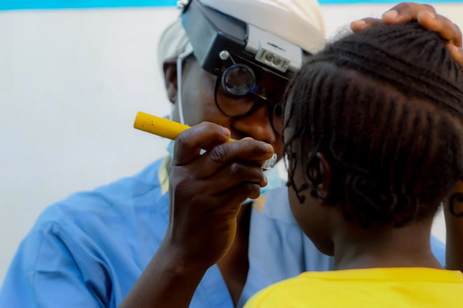 Patient receiving eye care support from Embrace Relief mobile clinic