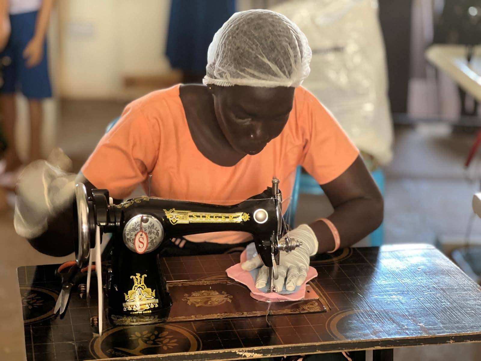 Woman sewing reusable menstrual pads as part of sustainable hygiene initiative