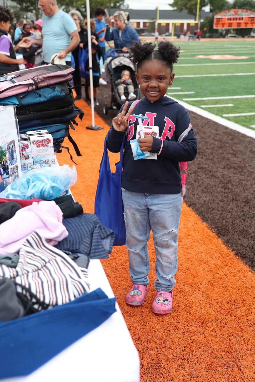 Student with a new backpack from the Embrace USA Backpack Drive