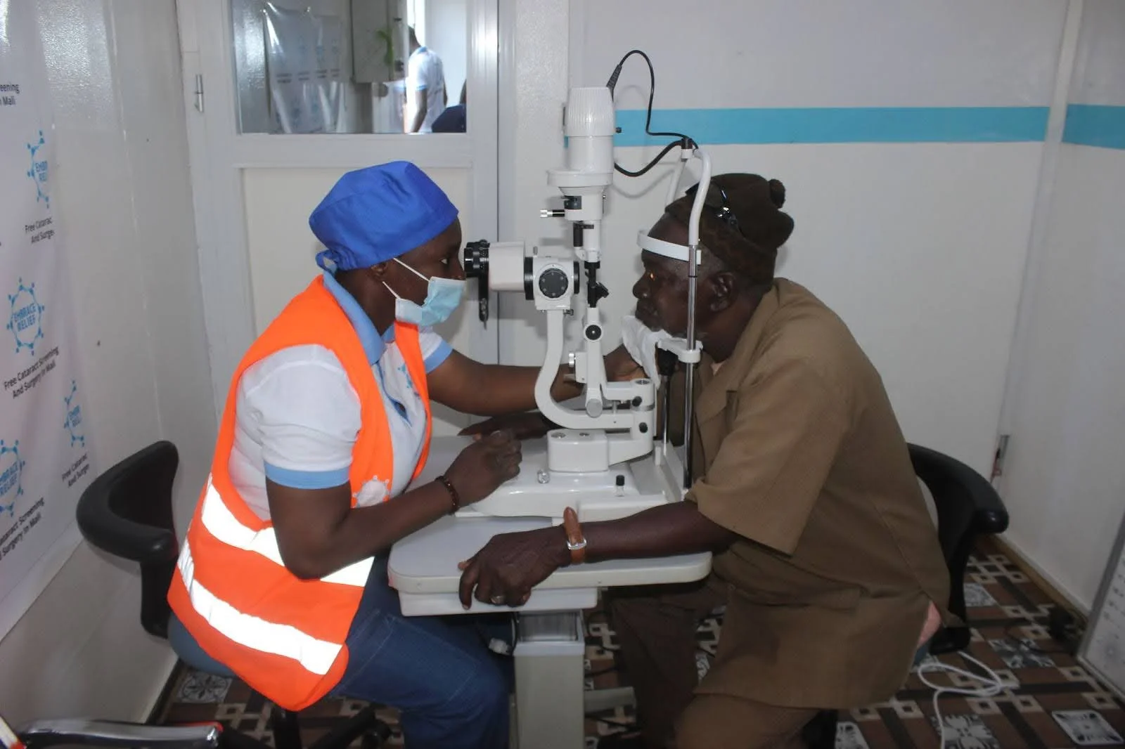 Embrace Relief volunteer assisting a patient in Mali with eye care