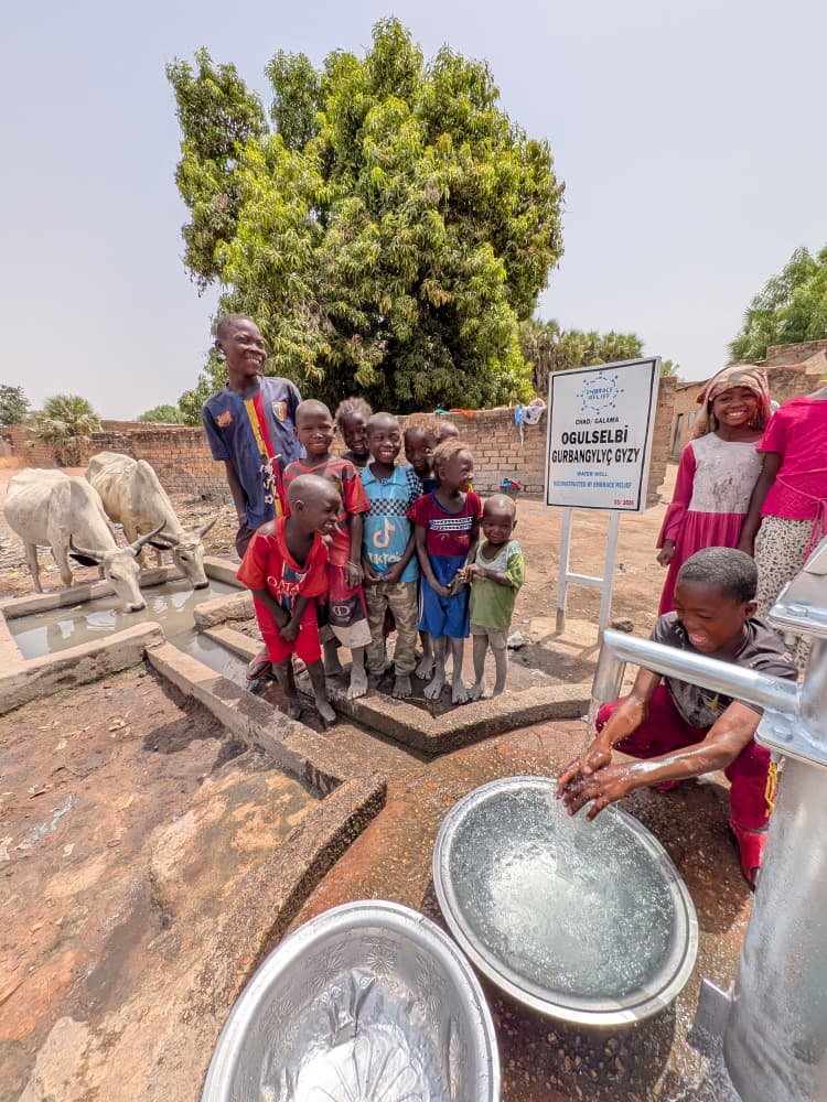 Community member standing near a water well in Tanzania