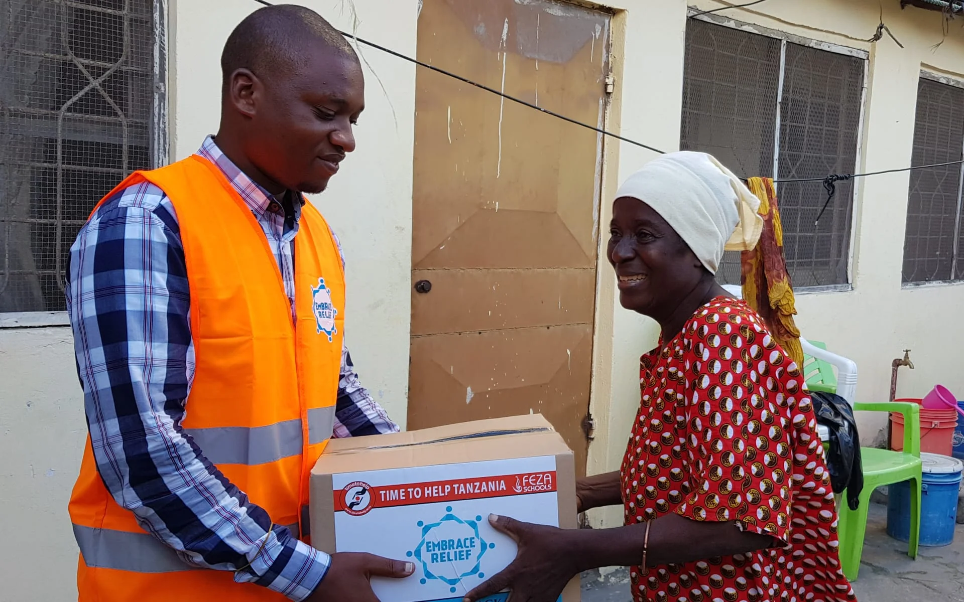Elderly woman in Tanzania receiving a food pack