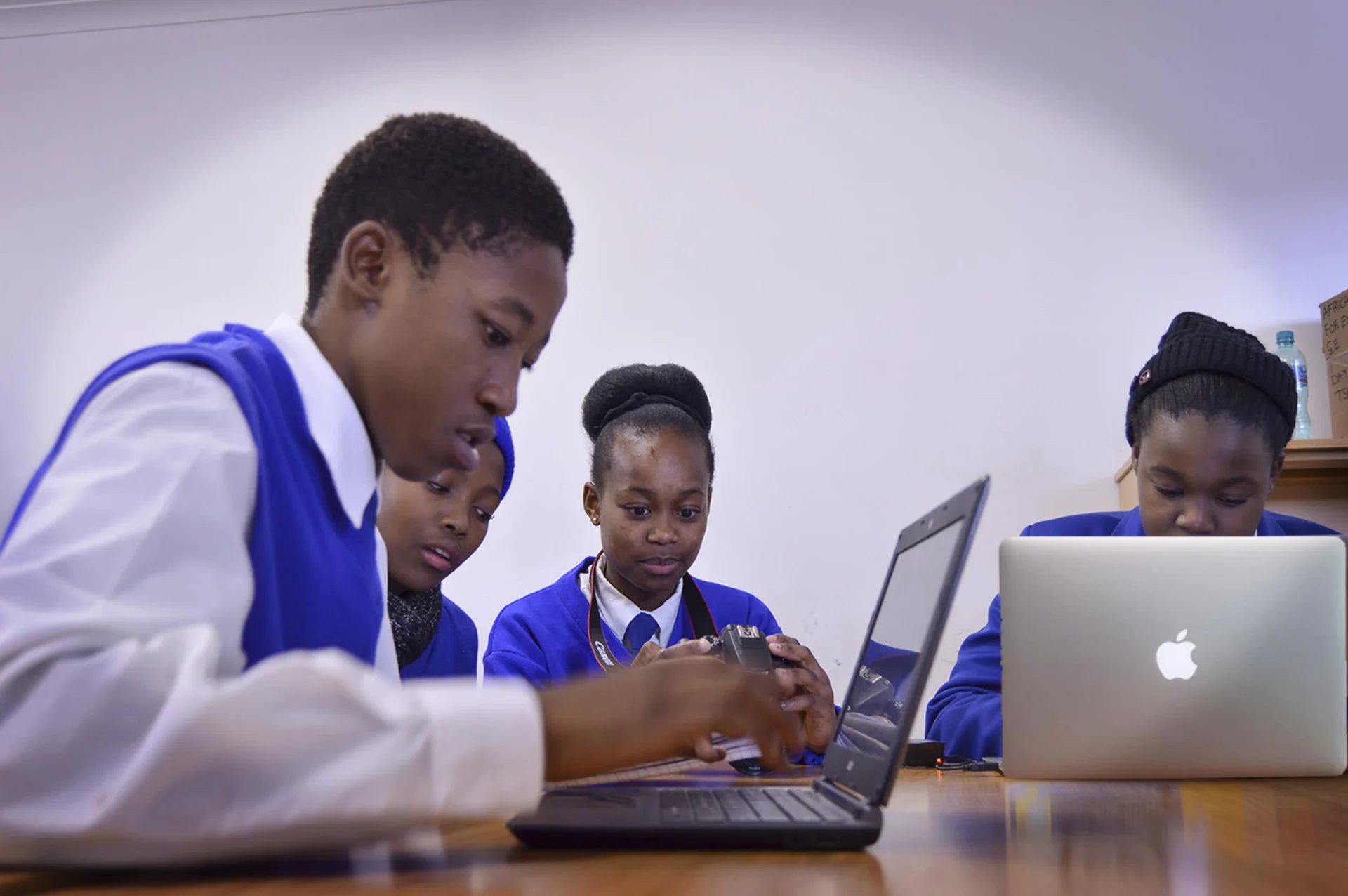 Children in Sub-Saharan Africa engaging with new computer technology in a classroom setting