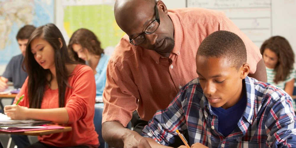 High school students taking a test in a classroom setting for the GradPlus program