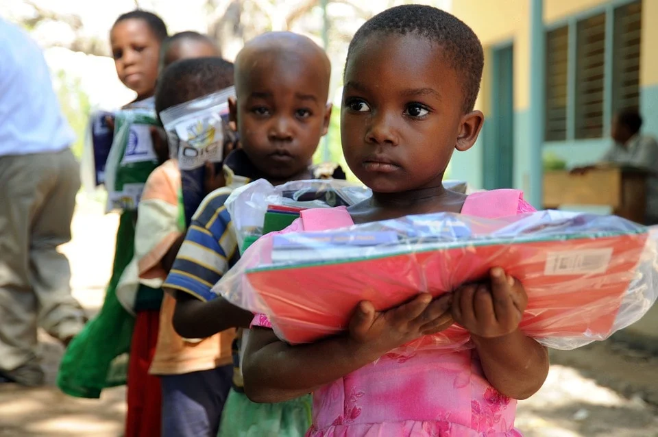 Tanzanian children standing outside an orphanage facility