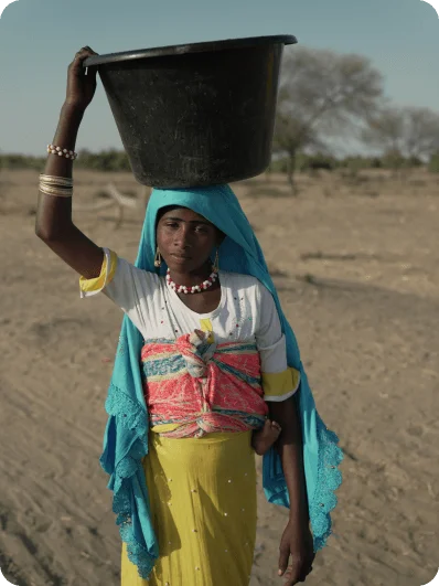 Woman collecting water from a well in Africa