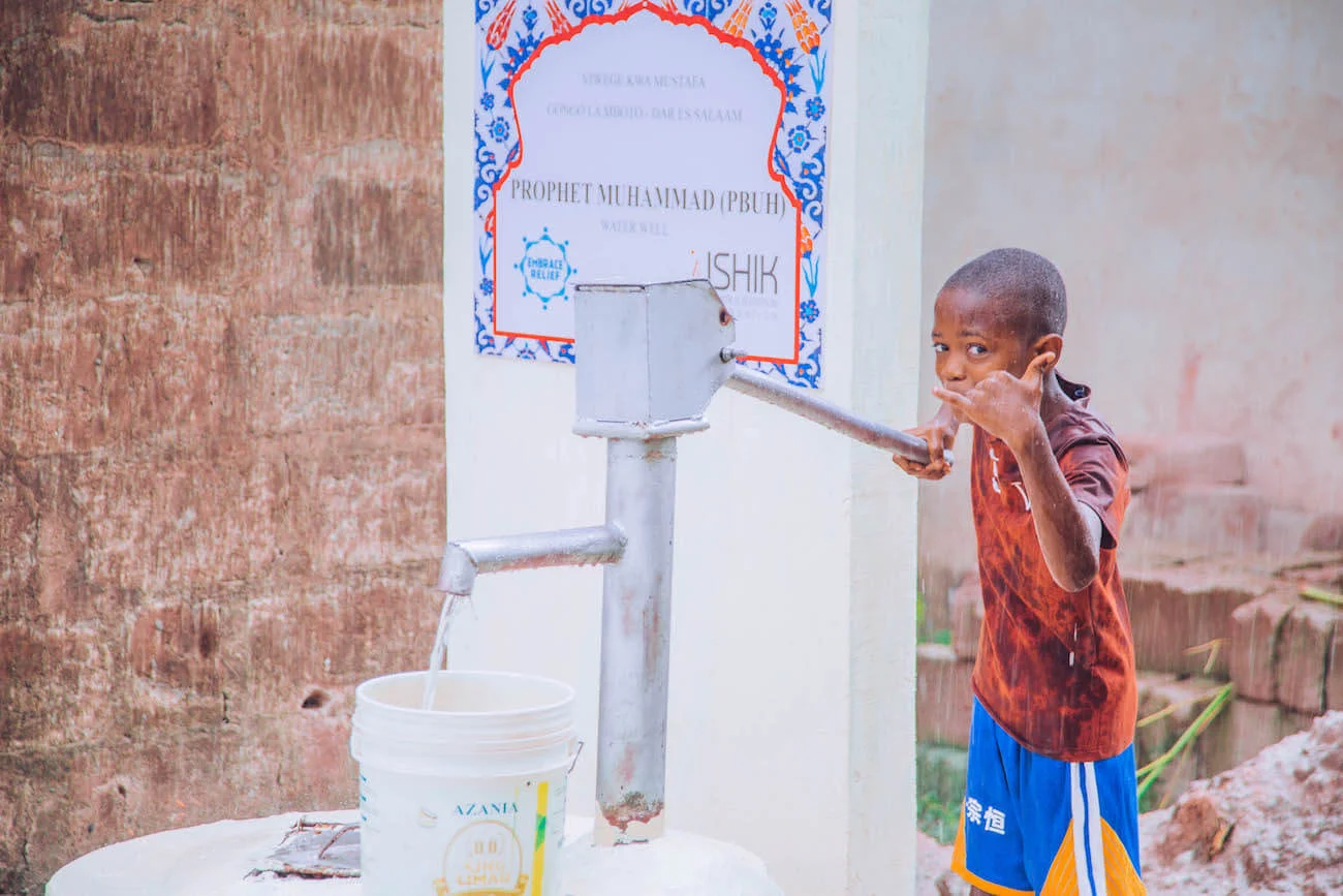 Community member accessing clean water from a well in Africa