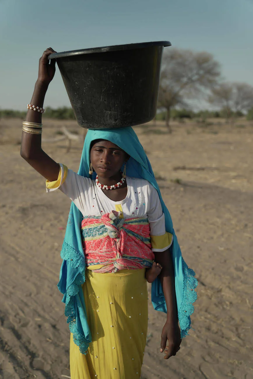 Woman standing near a water source in a rural African community